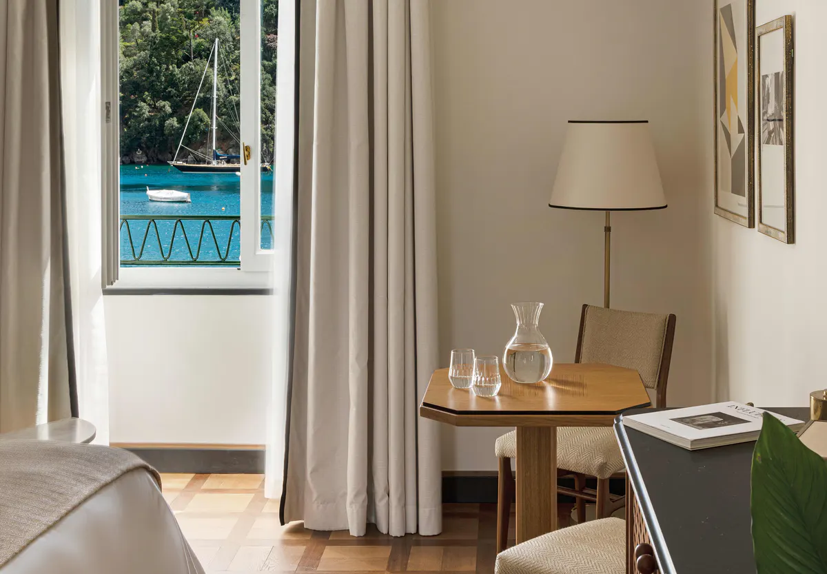 Suite with sea-view balcony, chair, and wooden table