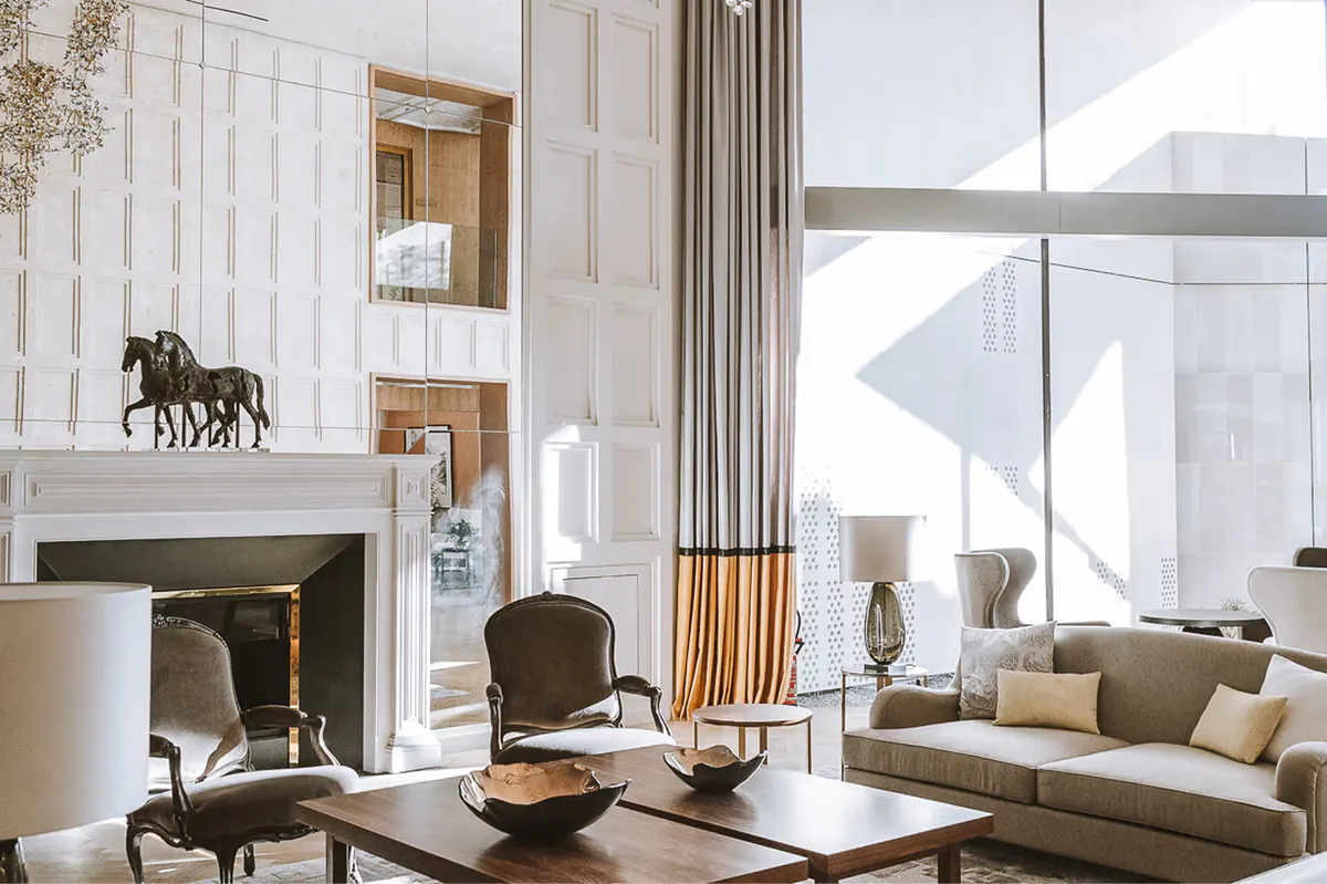 Contemporary lounge with fireplace, natural light, and modern furnishings
