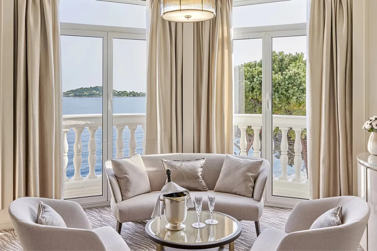 Seating area with plush armchairs and views of the sea from the balcony