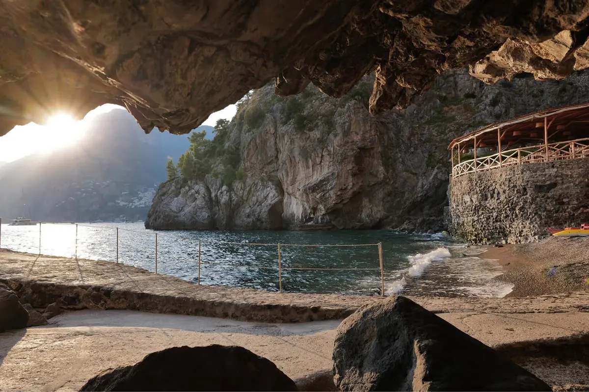 Private cove with natural rock formations, sea access, sand beach, and cliff edges