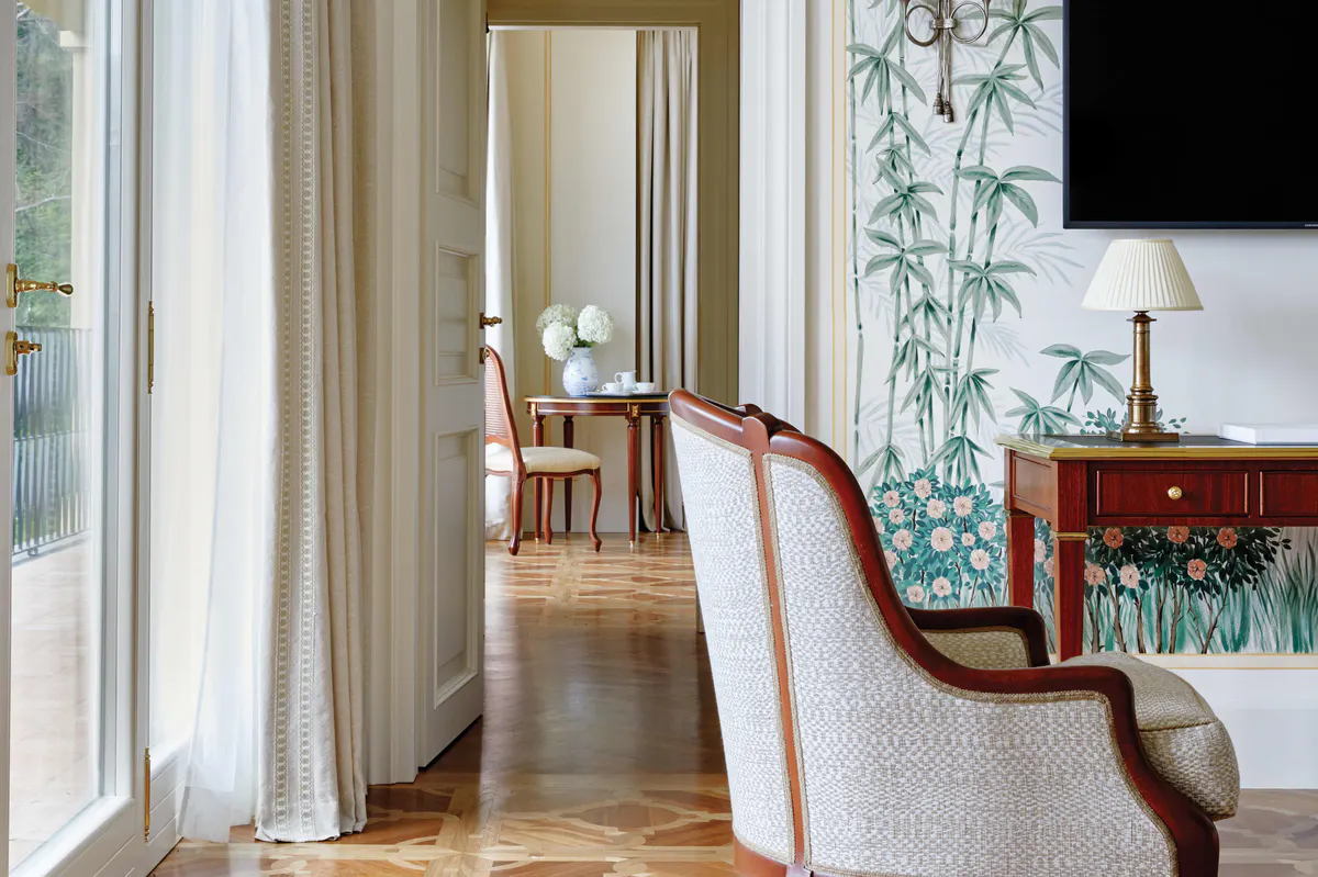 An interior hallway with ornate doors and transitions between living spaces