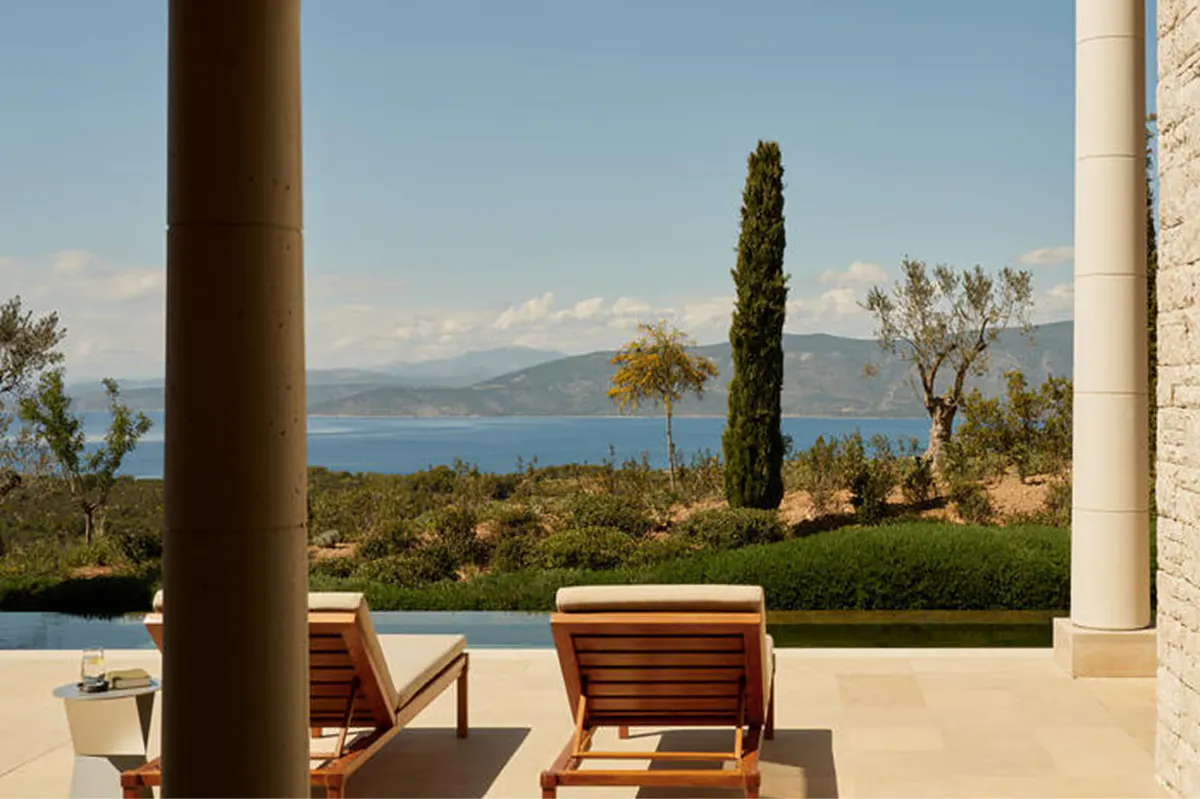 Seafront lounge area with daybed chairs and expansive water views
