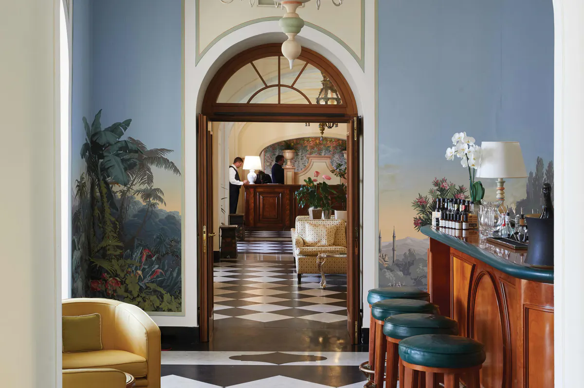 An interior dining room with arched entry, traditional furnishings, and refined décor