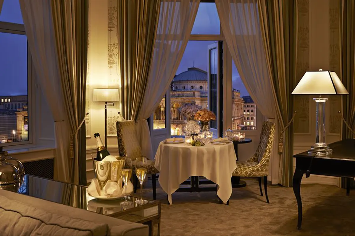Intimate dining room overlooking Copenhagen at dusk with curtained windows