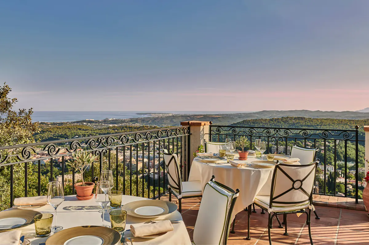 Terrace dining table at dusk with Mediterranean and village views