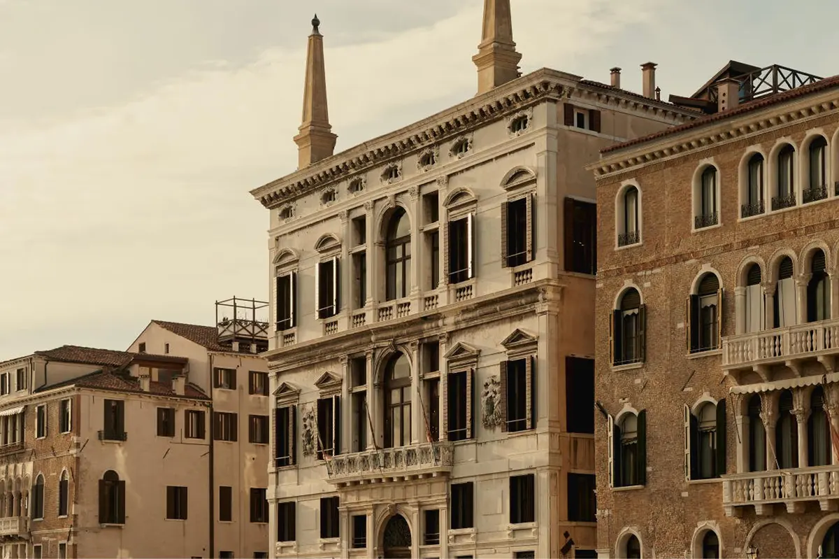 The palazzo facade with twin spires and ornate detailing facing the Grand Canal