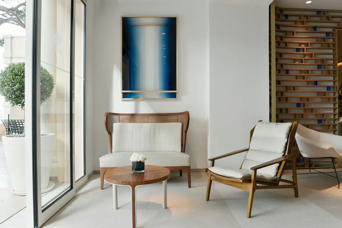 Living space with blue abstract artwork and wooden furniture