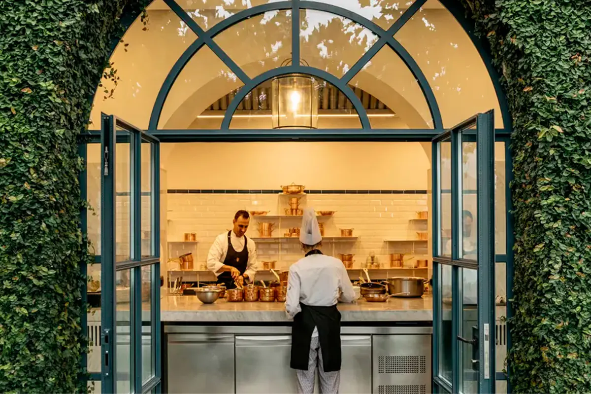 Ivy-framed restaurant entrance with arched glass doors